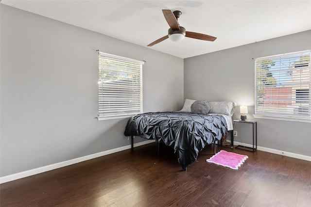 bedroom with ceiling fan and dark hardwood / wood-style flooring