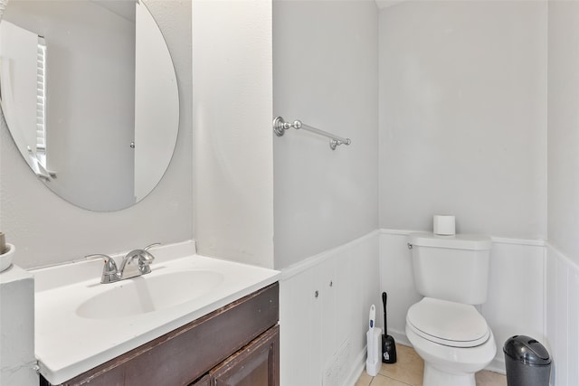 bathroom with vanity, toilet, and tile patterned flooring