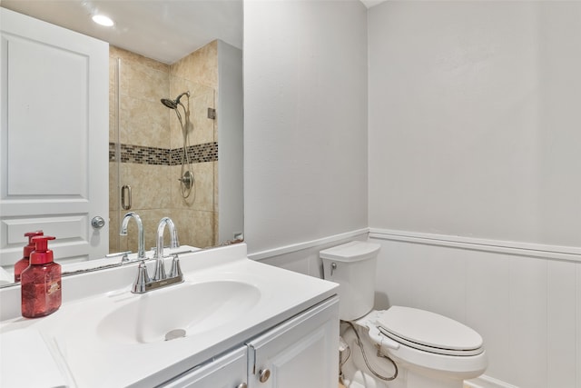 bathroom featuring toilet, an enclosed shower, and vanity