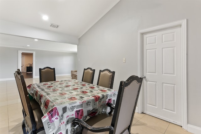 tiled dining room featuring lofted ceiling