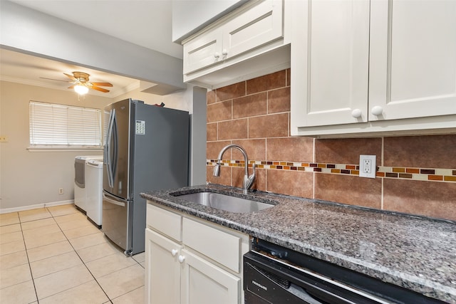 kitchen with sink, dishwasher, backsplash, stainless steel refrigerator, and washer and clothes dryer