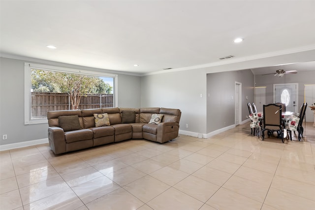 tiled living room with ornamental molding and ceiling fan