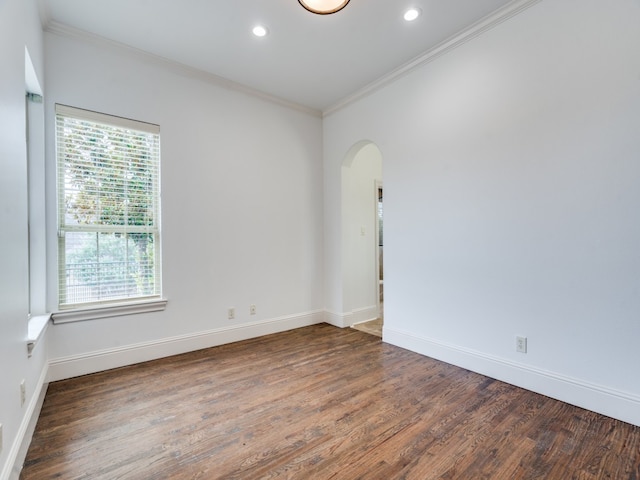 spare room with crown molding and dark hardwood / wood-style flooring