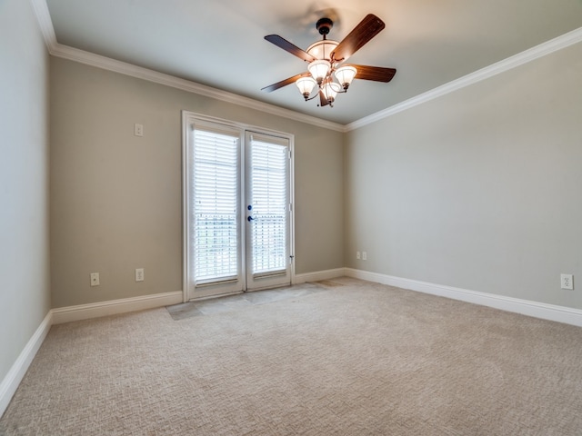 carpeted spare room featuring crown molding and ceiling fan