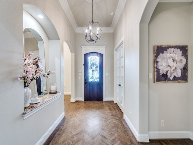 entrance foyer featuring a notable chandelier, parquet flooring, and crown molding