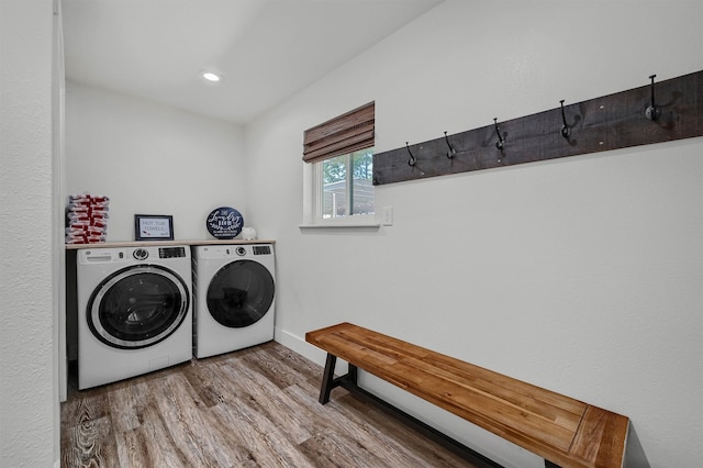 laundry room featuring separate washer and dryer and hardwood / wood-style floors