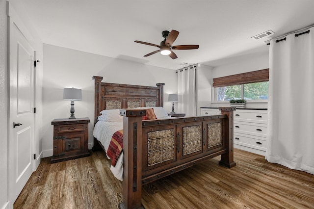 bedroom with dark wood-type flooring and ceiling fan