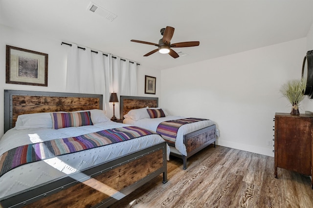 bedroom with wood-type flooring and ceiling fan