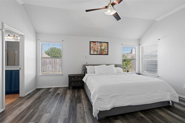 bedroom with ceiling fan, connected bathroom, vaulted ceiling, dark wood-type flooring, and crown molding