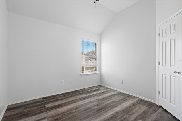 spare room featuring dark wood-type flooring, ceiling fan, and lofted ceiling