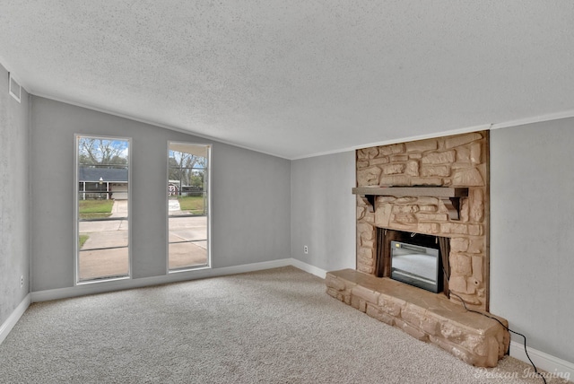 unfurnished living room featuring a stone fireplace, a textured ceiling, lofted ceiling, and carpet floors