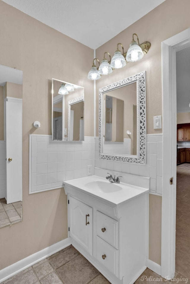 bathroom featuring vanity, decorative backsplash, and tile patterned flooring