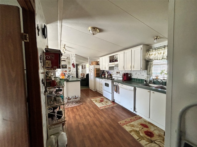 kitchen with white appliances, sink, backsplash, dark hardwood / wood-style flooring, and white cabinets