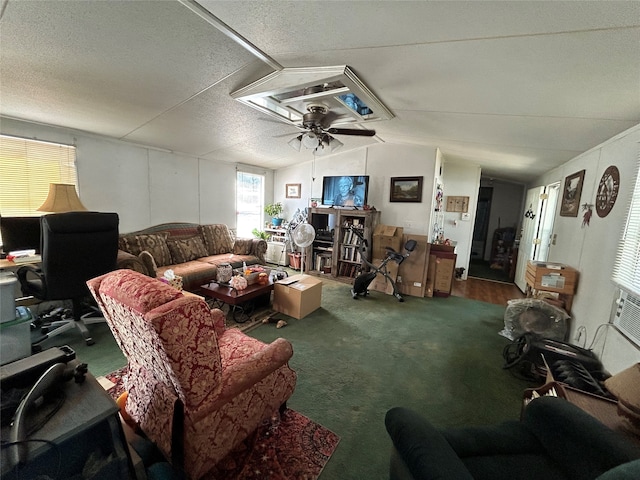 living room with carpet, ceiling fan, a textured ceiling, and lofted ceiling