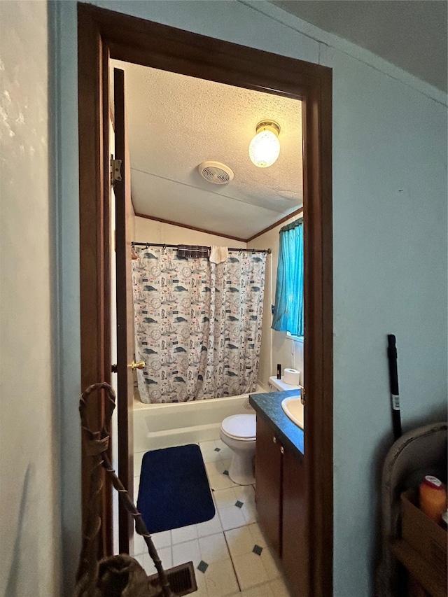 full bathroom with a textured ceiling, shower / bath combo with shower curtain, toilet, vanity, and tile patterned floors