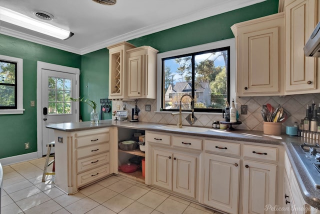 kitchen with crown molding, decorative backsplash, a healthy amount of sunlight, and light tile patterned floors