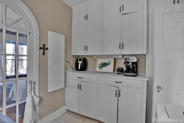 kitchen featuring white cabinetry and light tile patterned flooring