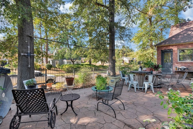 view of patio with outdoor dining space and fence