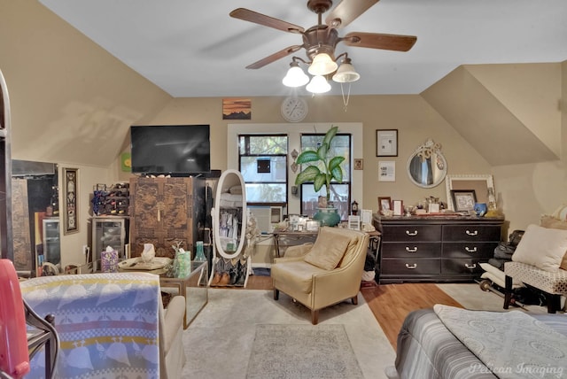 bedroom with light hardwood / wood-style flooring, lofted ceiling, and ceiling fan