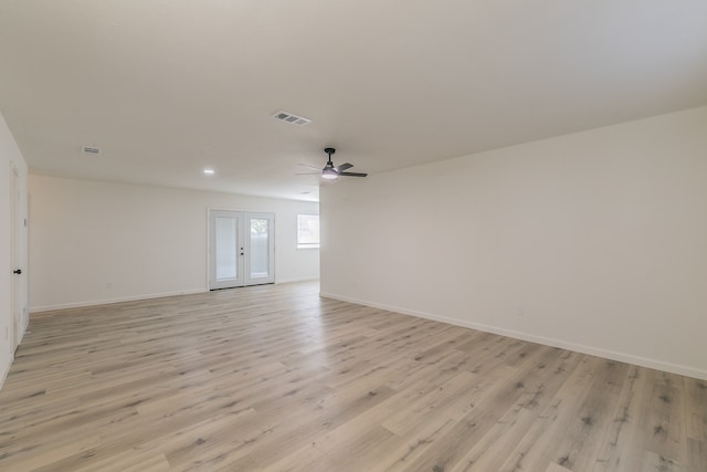 spare room with french doors, light hardwood / wood-style flooring, and ceiling fan