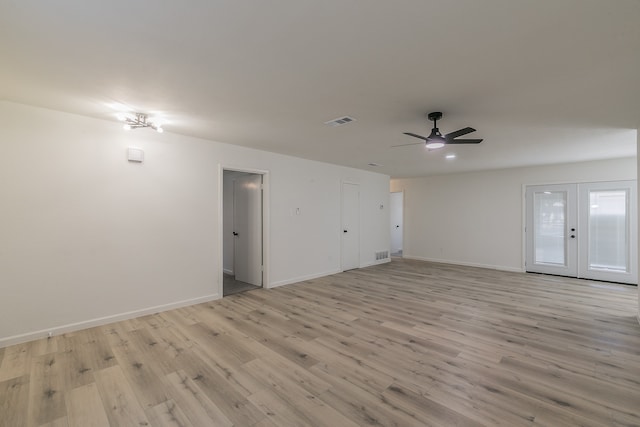 unfurnished room with ceiling fan, light wood-type flooring, and french doors