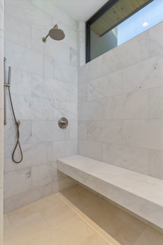 bathroom with a tile shower