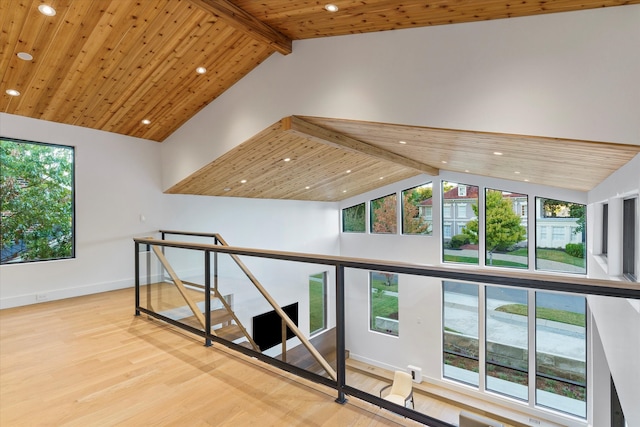 interior space with beamed ceiling, a healthy amount of sunlight, and light wood-type flooring