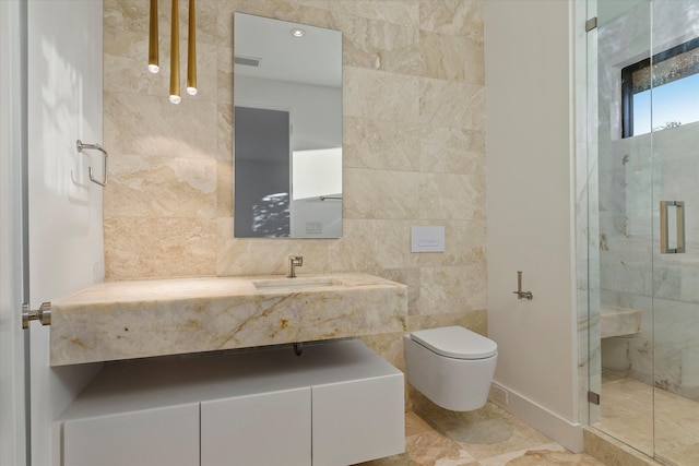 bathroom with vanity, toilet, a shower with shower door, and tile walls