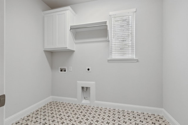 washroom featuring baseboards, light floors, electric dryer hookup, cabinet space, and washer hookup