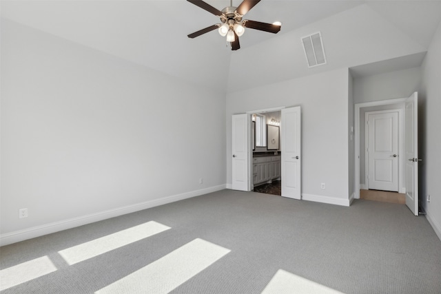 unfurnished bedroom featuring connected bathroom, ceiling fan, high vaulted ceiling, and carpet flooring