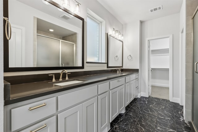 bathroom featuring vanity and an enclosed shower