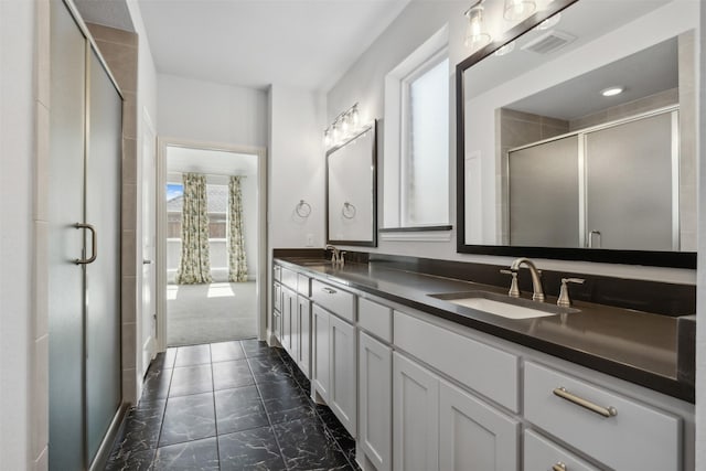 bathroom featuring visible vents, a sink, marble finish floor, and a shower stall