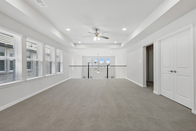 unfurnished living room with ceiling fan with notable chandelier, carpet floors, and a healthy amount of sunlight