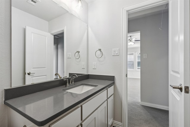 bathroom featuring baseboards, visible vents, ceiling fan, and vanity