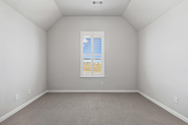 additional living space featuring visible vents, carpet, baseboards, and vaulted ceiling