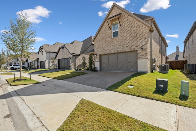 view of front facade with a front lawn, central AC unit, and a garage