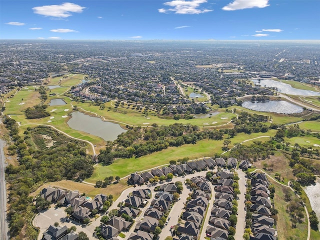 drone / aerial view featuring a water view, golf course view, and a residential view