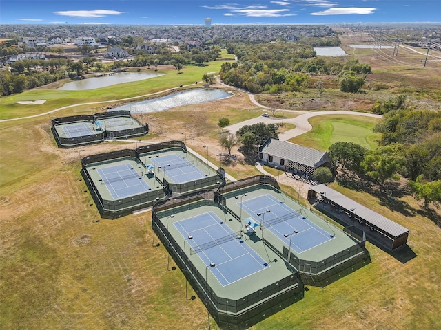 drone / aerial view with a water view and golf course view
