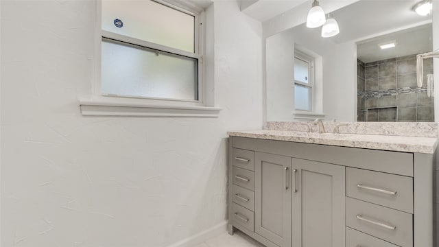 bathroom featuring vanity and a tile shower