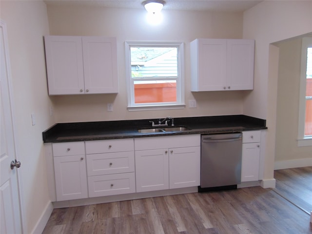 kitchen with sink, dishwasher, white cabinetry, and light wood-type flooring