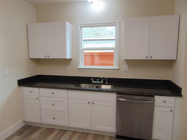 kitchen with white cabinetry, light hardwood / wood-style flooring, sink, and stainless steel dishwasher