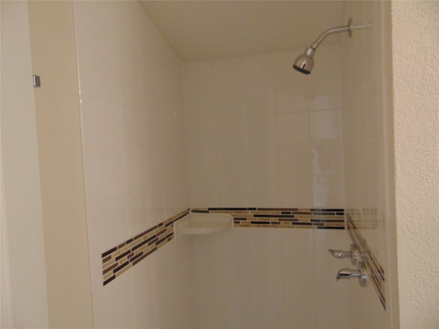 bathroom with a tile shower