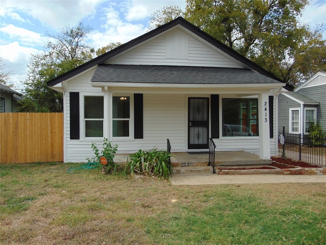 bungalow with a front yard and covered porch