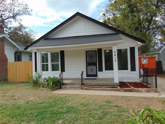 bungalow-style home featuring a porch and a front yard