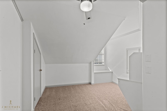 spacious closet with lofted ceiling, carpet flooring, and ceiling fan