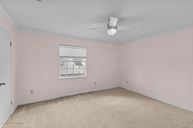 carpeted spare room with crown molding and ceiling fan