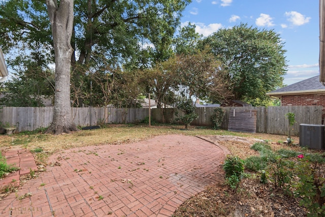 view of yard with cooling unit and a patio area