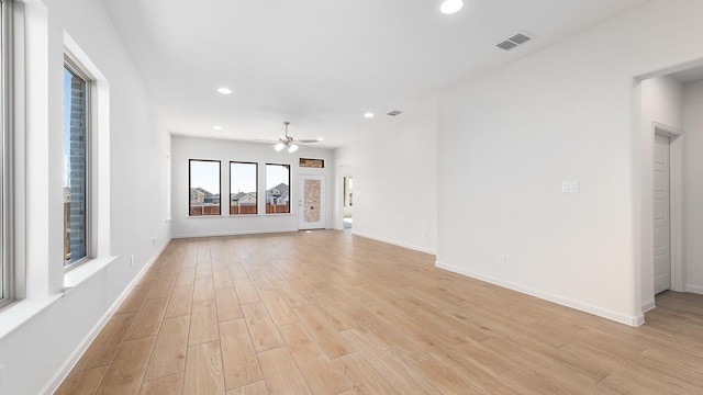 unfurnished living room with ceiling fan and light wood-type flooring