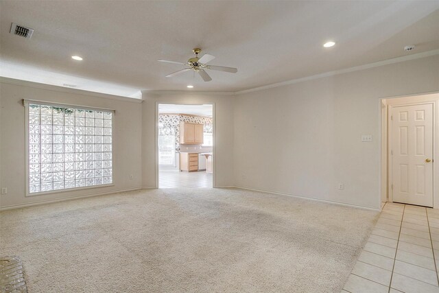 carpeted empty room featuring crown molding and ceiling fan