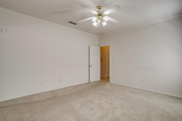 carpeted empty room featuring ornamental molding and ceiling fan